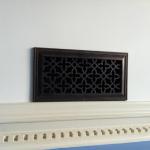 heritage decorative vent cover on wall above moulding